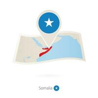 Folded paper map of Somalia with flag pin of Somalia. vector