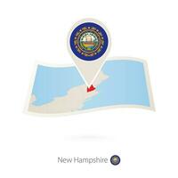 Folded paper map of New Hampshire U.S. State with flag pin of New Hampshire. vector