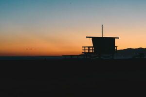 Sunset over Baywatch booths in California photo