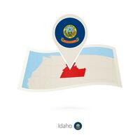 Folded paper map of Idaho U.S. State with flag pin of Idaho. vector