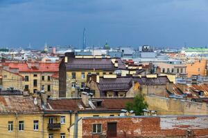 view of the roofs of the historical center of St. Petersburg during the rain photo