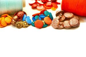 Assorted tailor's buttons, spools of thread for sewing clothes photo