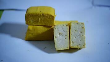 yellow tofu isolated on white background. soft yellow tofu isolated on white background. fresh yellow tofu isolated on white background photo