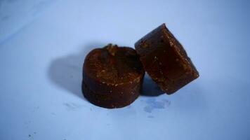 black cylindrical palm sugar isolated on white background, top view photo
