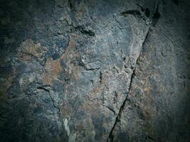 Black stone background. Long black stone texture and textured. Dirty black stone wall. Rock texture with cracks. stone tile floor texture. Old wall texture abstract natural background. photo