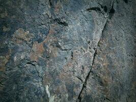 Black stone background. Long black stone texture and textured. Dirty black stone wall. Rock texture with cracks. stone tile floor texture. Old wall texture abstract natural background. photo