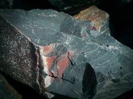 Black stone background. Long black stone texture and textured. Dirty black stone wall. Rock texture with cracks. stone tile floor texture. Old wall texture abstract natural background. photo