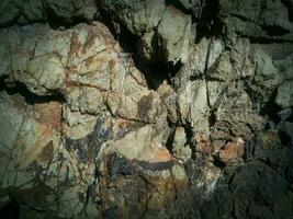 Black stone background. Long black stone texture and textured. Dirty black stone wall. Rock texture with cracks. stone tile floor texture. Old wall texture abstract natural background. photo