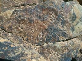 Black stone background. Long black stone texture and textured. Dirty black stone wall. Rock texture with cracks. stone tile floor texture. Old wall texture abstract natural background. photo