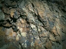 Black stone background. Long black stone texture and textured. Dirty black stone wall. Rock texture with cracks. stone tile floor texture. Old wall texture abstract natural background. photo