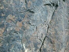 Black stone background. Long black stone texture and textured. Dirty black stone wall. Rock texture with cracks. stone tile floor texture. Old wall texture abstract natural background. photo