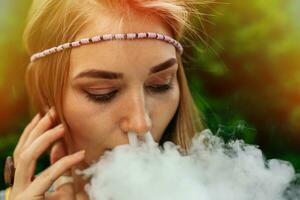 Happy vaping young white blonde girl photo