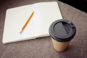 Pencil, notebook and paper coffee cup photo