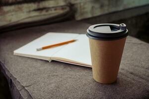 Pencil, notebook and paper coffee cup photo