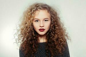 Beauty young woman with curly big and long hair. photo