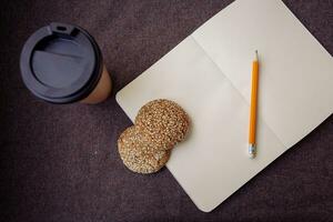 Pencil, notebook and paper coffee cup photo