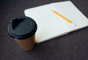 Pencil, notebook and paper coffee cup photo