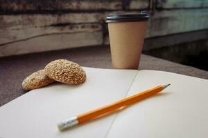 Pencil, notebook and paper coffee cup photo