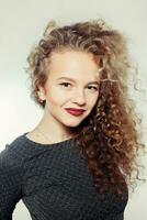 Beauty young woman with curly big and long hair. photo