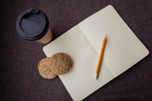 Pencil, notebook and paper coffee cup photo