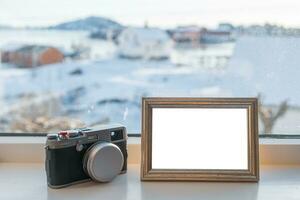 Vintage Camera with blank picture frame on window sill photo