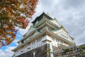 Architecture Osaka Castle with autumn tree photo