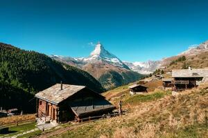 Matterhorn mountain, Swiss alps over mountain huts in autumn at Findeln, Zermatt, Switzerland photo