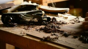 Luthier sanding wood to manufacture a new guitar in workplace video