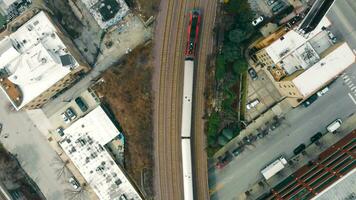 Top view of a subway passenger train traveling in Chicago Illinois. The infrastructure of the city from a bird's eye view and the train and railway. video