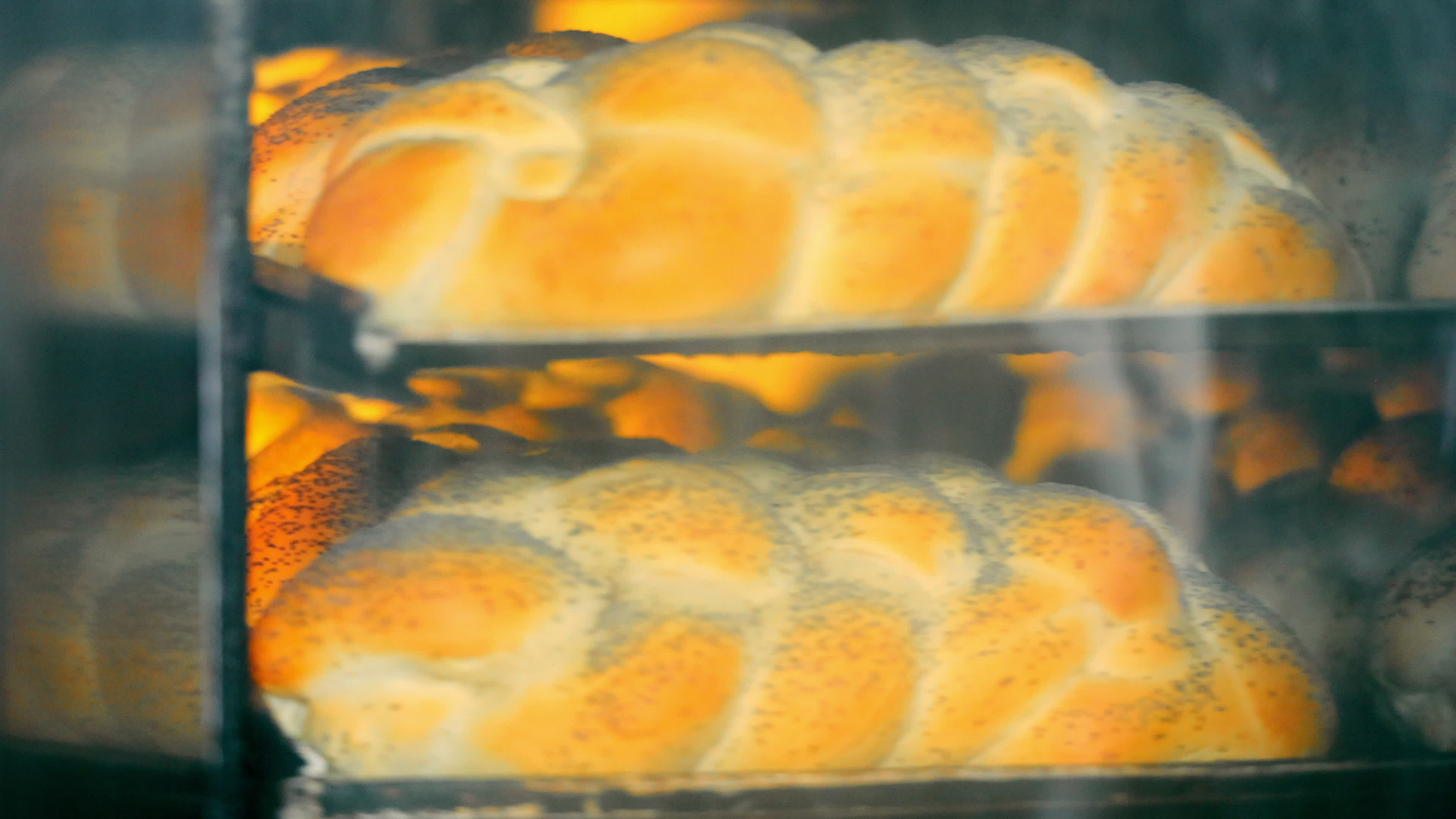 Baking Bread in Oven. View of bread loaves baking in the heat of a