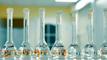 Volumetric Flasks in Science Lab. Row of volumetric flasks with clear liquid in a scientific laboratory. video