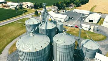 Aerial view of metal silos for grain storage. Modern grain storage plant, grain storage tanks - a flight around Metal silos video