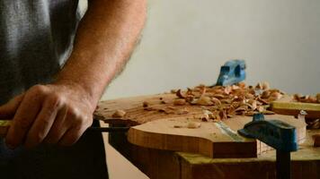 Luthier working with a chisel in workplace video