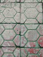 A floor made of grey paving blocks or concrete blocks. photo