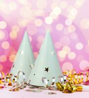 Party hats and beautiful bokeh on a pink background. Close-up. photo