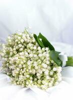 Bouquet beautiful lilies of the valley on a white background. Greeting card. Selective focus. photo