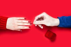 Man making marriage proposal and puts a ring on a girl's finger. Close-up. Top view. photo