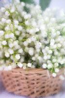 Basket with lilies of the valley outside the window on a rainy day. Close-up. Selective focus. photo