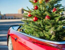 Christmas background with snow and red car christmas tree photo