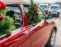 Christmas background with snow and red car christmas tree photo