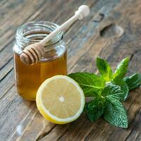 Honey in jar with honey dipper on vintage wooden background photo