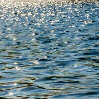 ocean water background abstract background of seawater flow under light exposure photo