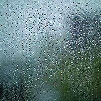 water drops on the glass wet window glass with splashes and drops of water photo