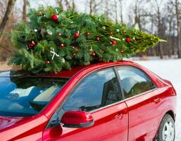 Christmas background with snow and red car christmas tree photo