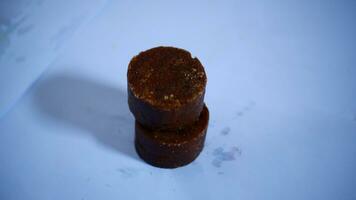 black cylindrical palm sugar isolated on white background, top view photo