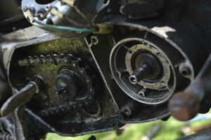 Repair of an old motorcycle. Analysis of the generator. Internal parts of the motor. photo