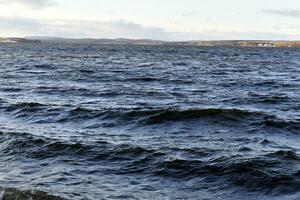 Black waves of the reservoir in winter in the mountains. The dark waters of the reservoir in Yekaterinburg. photo