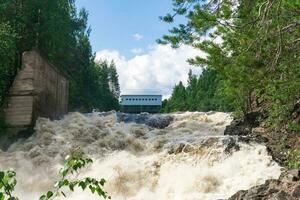 waterfall during opened locks for idle discharge of water at a small hydroelectric power station photo