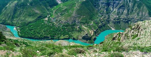 top view of the mountain river Sulak in Dagestan with the village of Old Zubutli with a boat pier photo