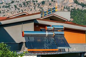 solar thermal collectors installed on the roof of a residential building photo